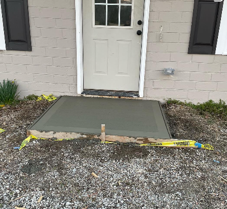 Newly installed concrete entrance pad in Auburn, GA by Georgia Peach Concrete LLC. Expert concrete services for patios, driveways, sidewalks, walkways, and more